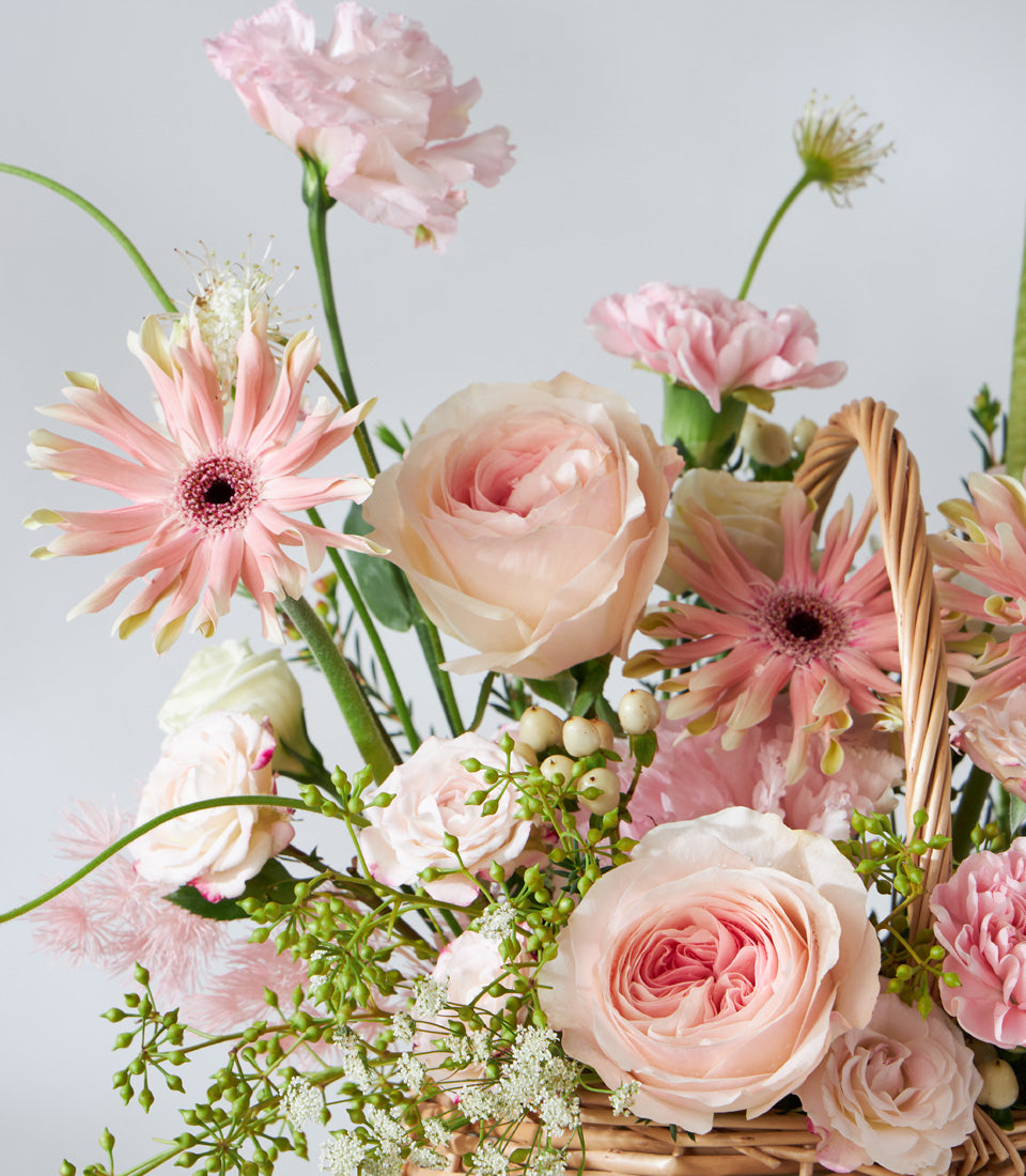 Blush Harmony woven basket with light pink roses, gerbera daisies, and carnations for birthday gifts