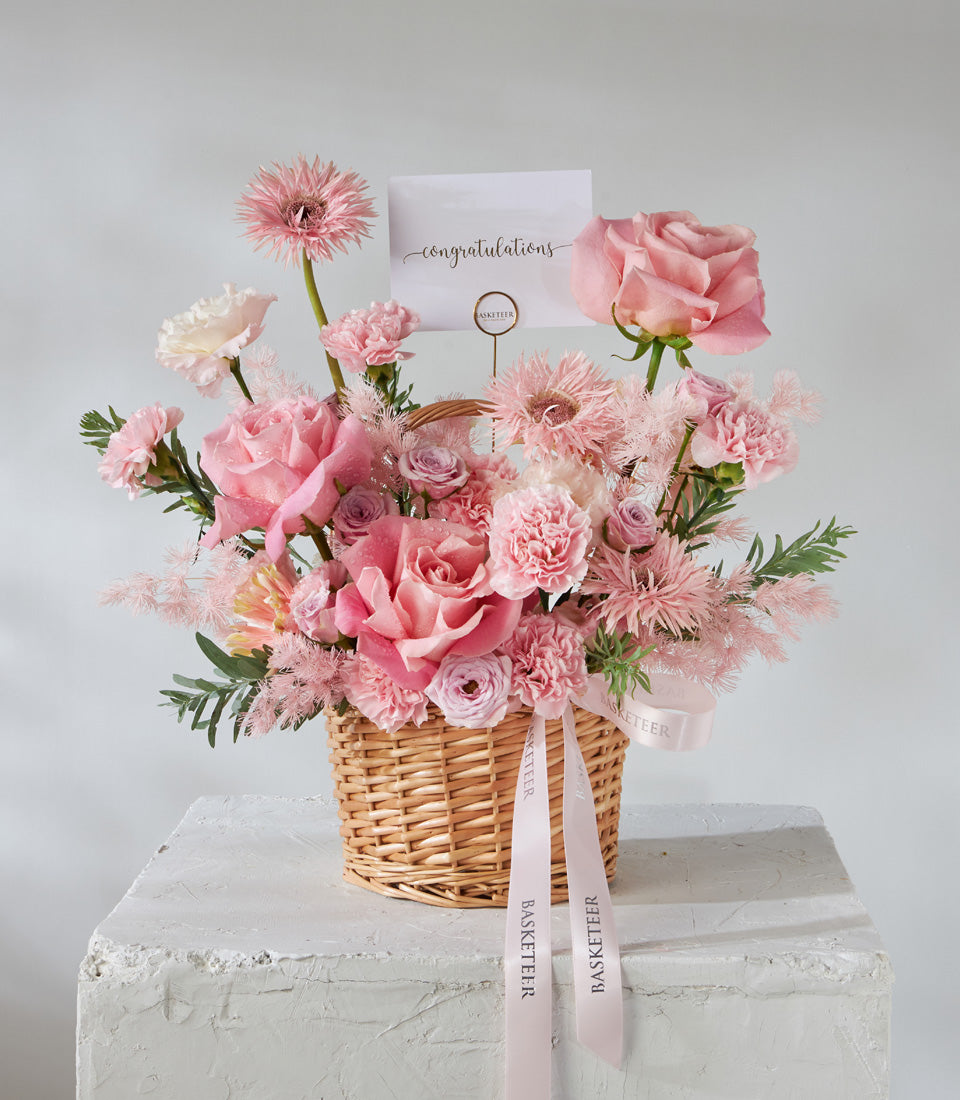 Pink and white rose basket with carnations and gerbera daisies, fresh birthday flowers in woven container