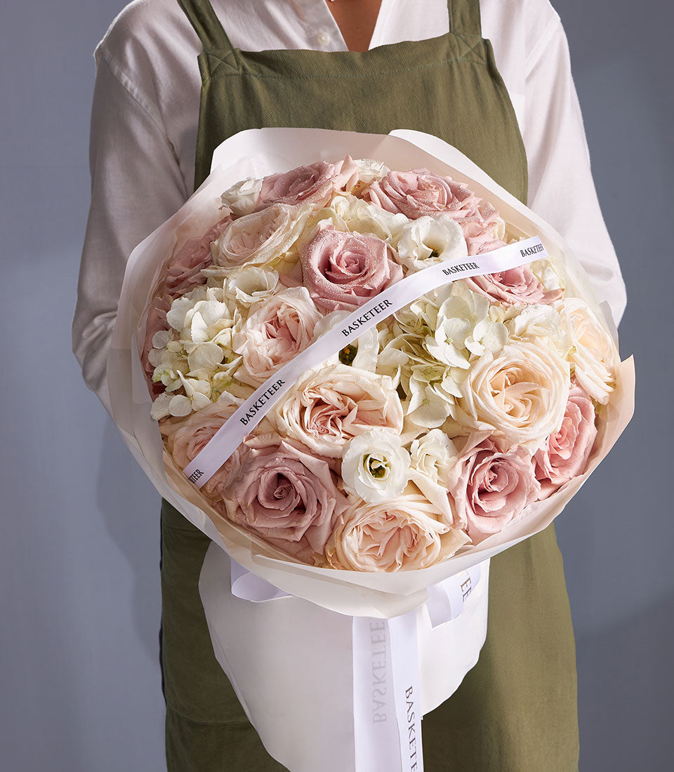 Timeless Grace mixed bouquet with pink roses, white hydrangeas, and eustoma wrapped in white paper