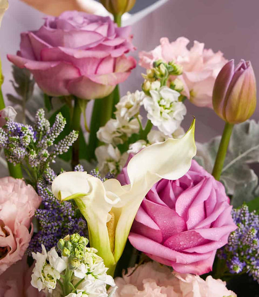 Lavender roses and white calla lilies fresh flower bouquet with stock and veronica