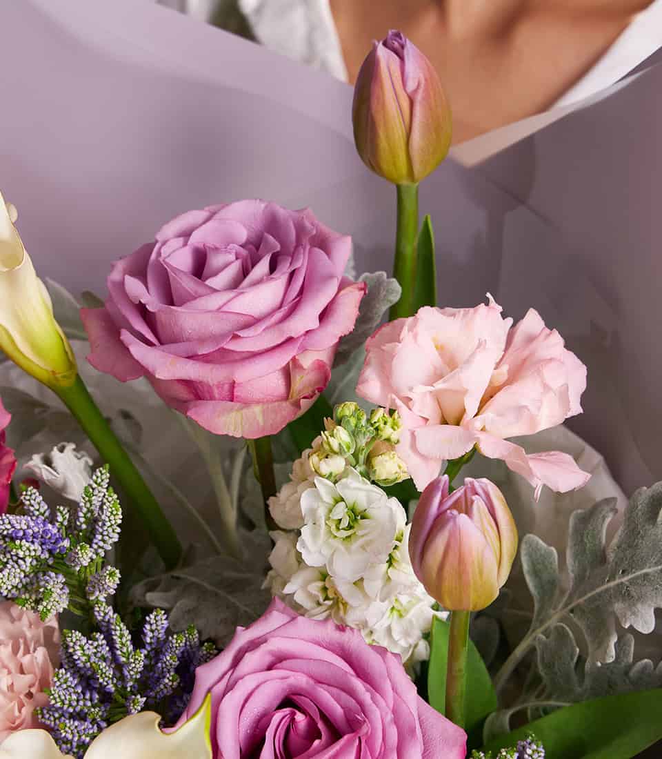 Lavender roses and white calla lilies bouquet in light purple wrapping, artisan fresh flowers for gifting
