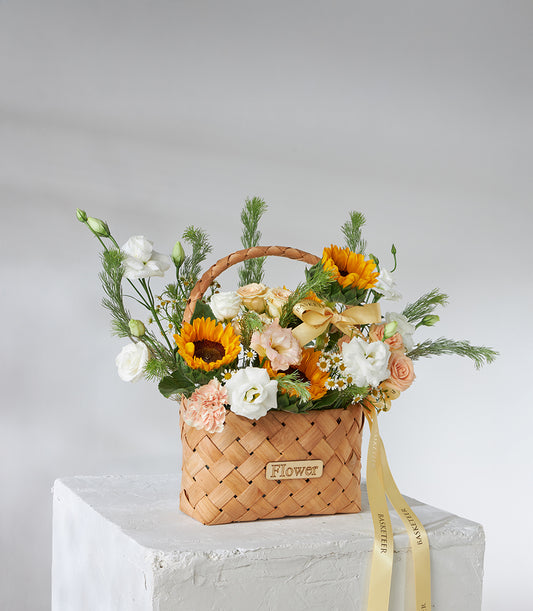 Sunflower, white rose and peach spray rose basket bouquet with golden ribbon for birthday gifting