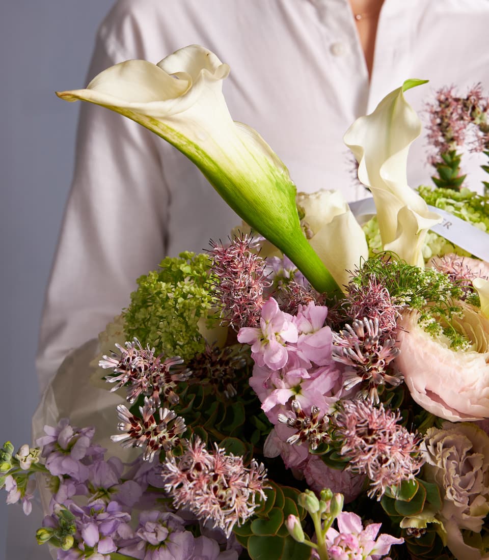 Ivory calla lily and pink stock bouquet with brunia accents, wrapped in cream ribbon