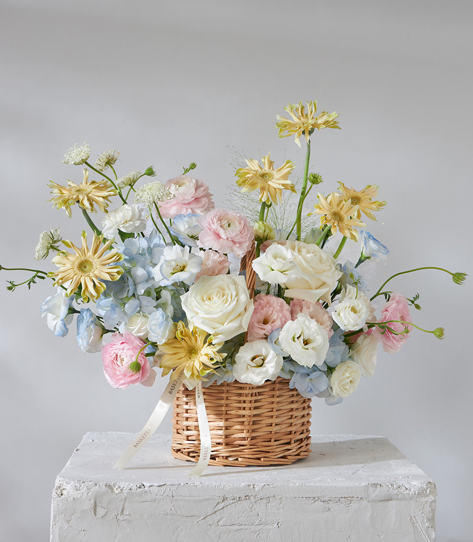 Pastel pink and white rose basket arrangement with hydrangeas and ranunculus, fresh flowers for birthday gifts