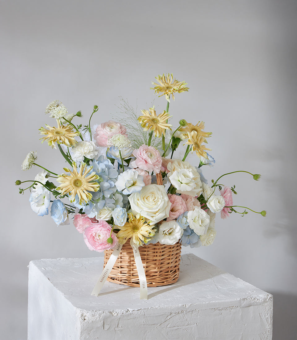 Pastel Radiance flower basket with hydrangeas, roses, and ranunculus for birthday celebrations