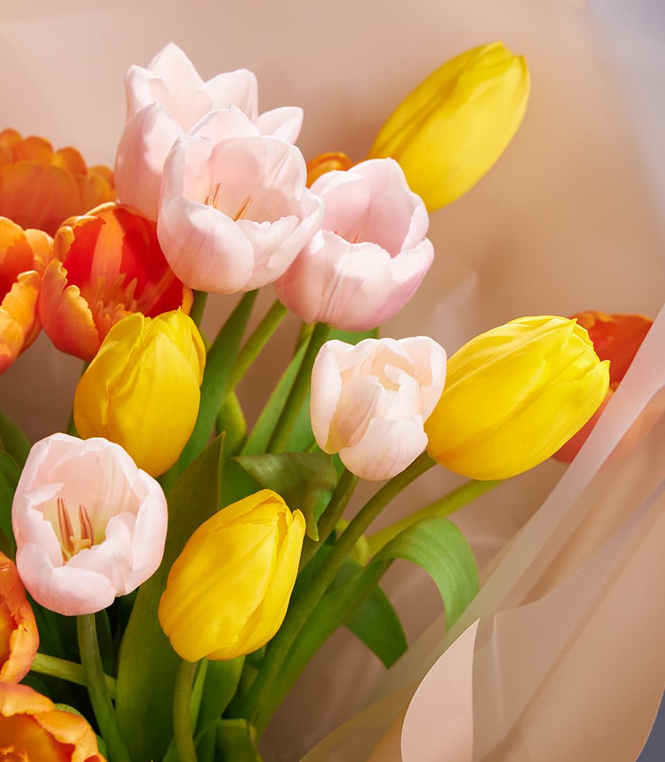 Yellow, orange & blush tulip bouquet with kraft paper wrap