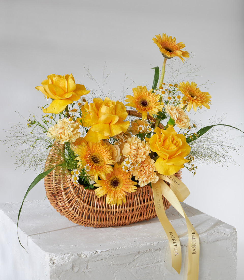 Golden Radiance Basket with yellow and orange roses, gerberas, and carnations for birthday celebrations