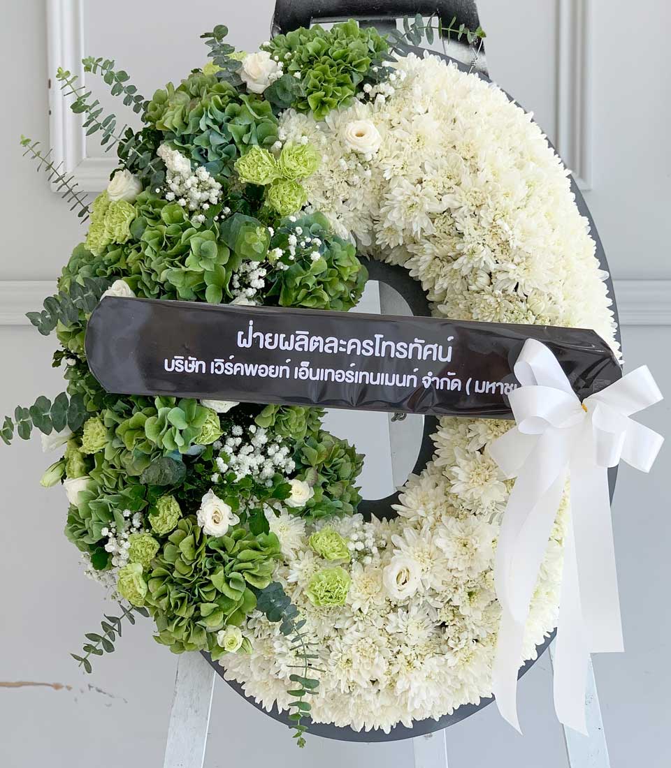 Fresh white chrysanthemum and green hydrangea funeral wreath with eucalyptus and baby's breath