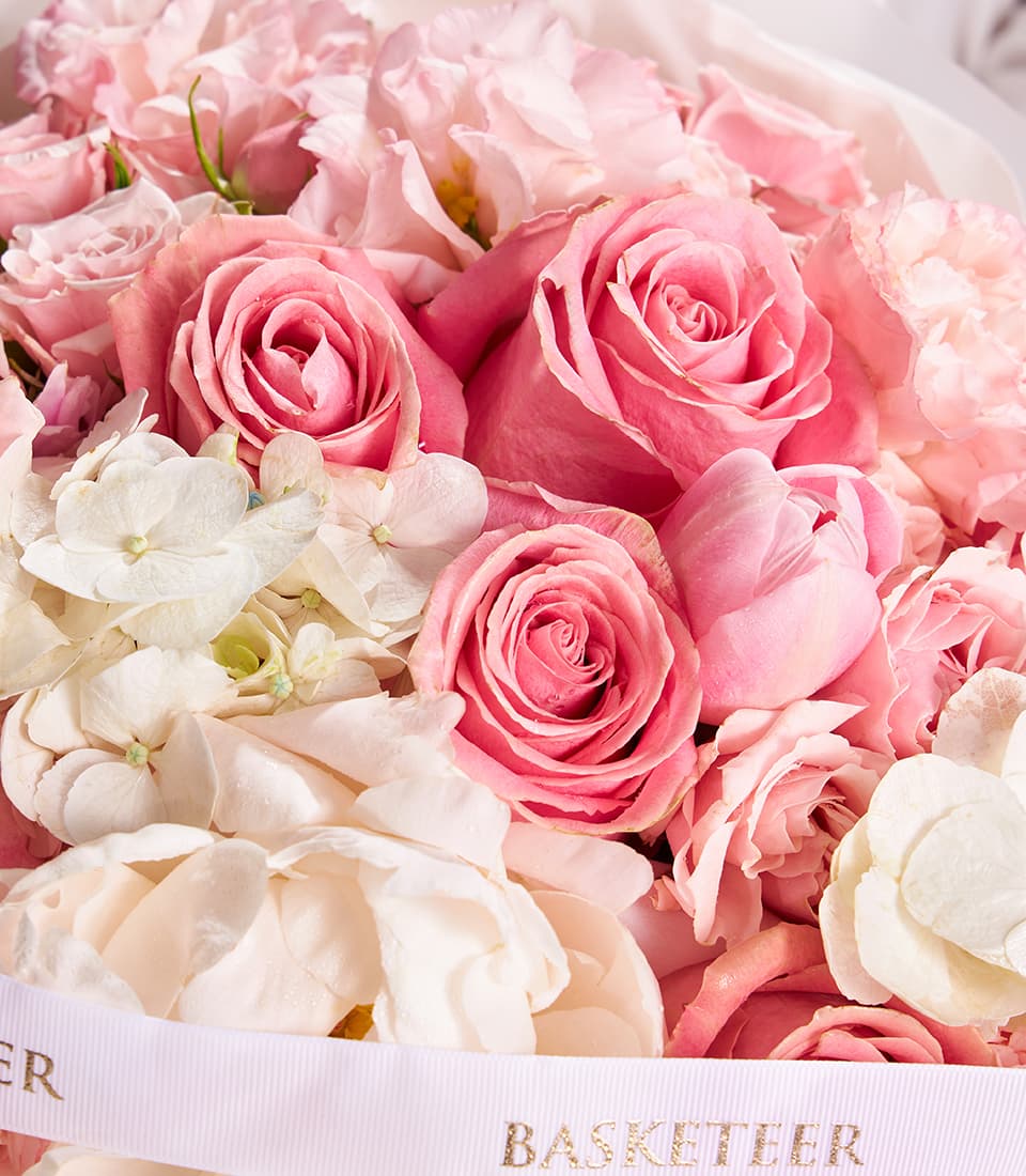 Blush peony rose hydrangea bouquet with pink and white fresh flowers and gold-trimmed ribbon