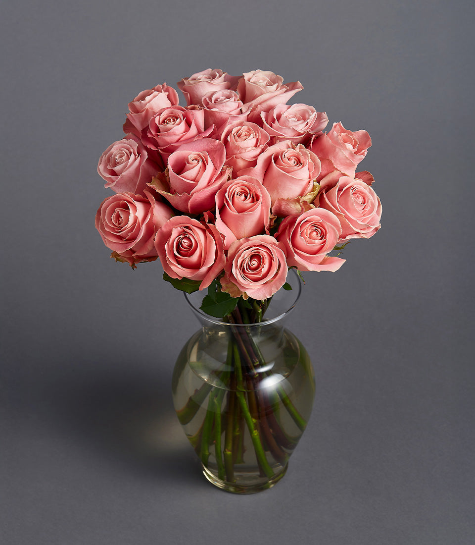 Soft pink roses in clear glass vase, artisan birthday flower gift basket
