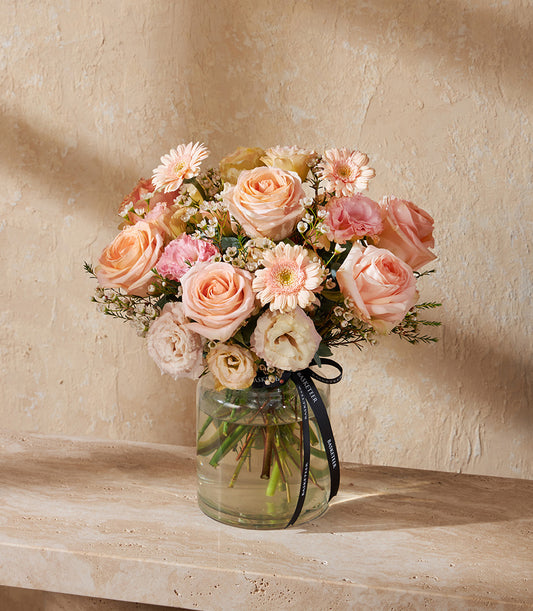 Peach and pink rose bouquet with gerberas in clear glass vase, fresh flower gift arrangement