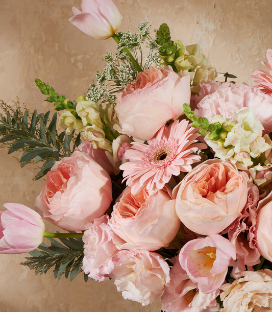 Pink roses and tulips with gerbera daisy in Juliet Elegance vase arrangement