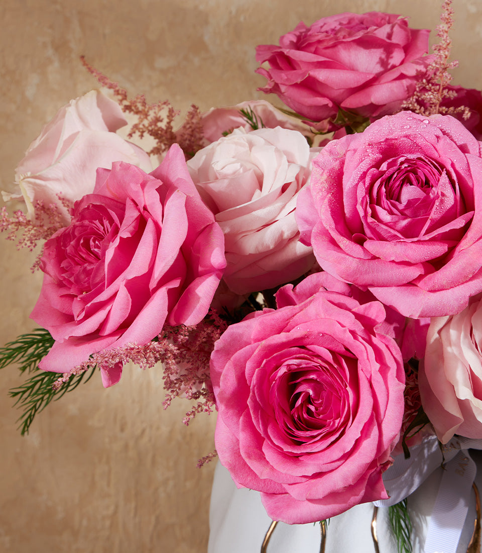 Blush Symphony rose vase with deep pink and pale pink roses, astilbe, and greenery in white gold-frame vase