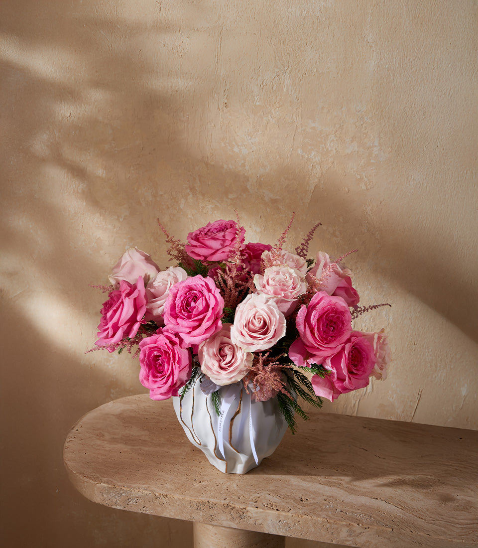 Blush pink roses and astilbe in sculptural grey vase with gold accents, premium fresh flower arrangement for gifting