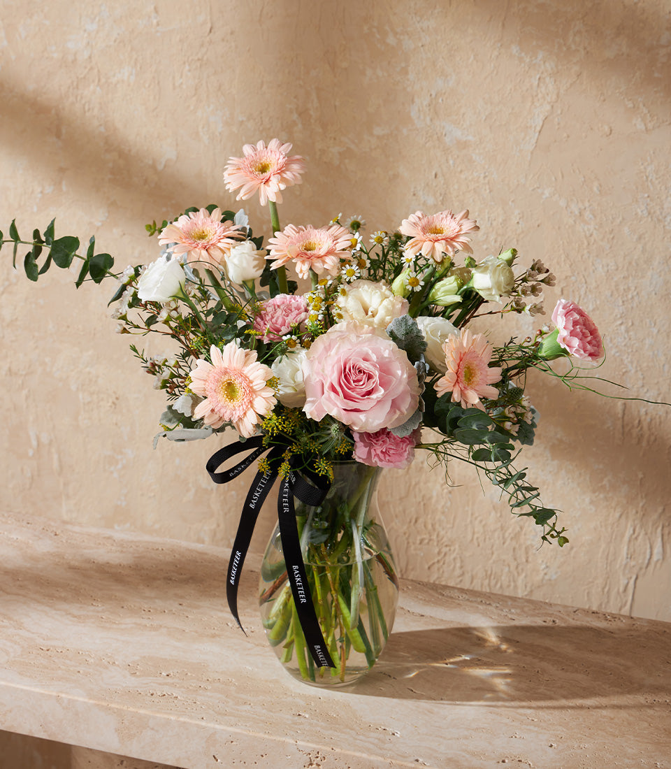 Blush Harmony vase arrangement with pink roses, gerbera daisies, and white eustoma for congratulations gifting
