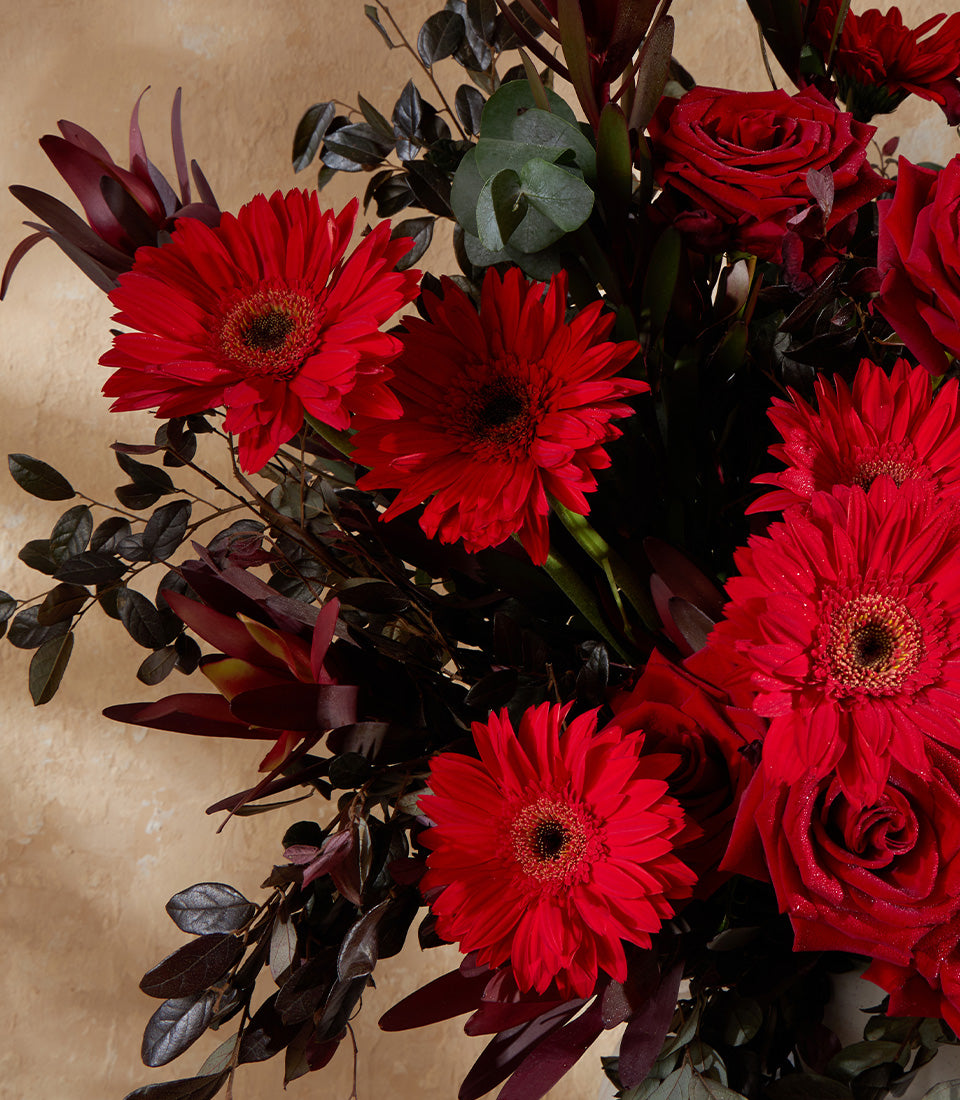 Crimson Elegance red rose and gerbera daisy vase arrangement with sparkle detail