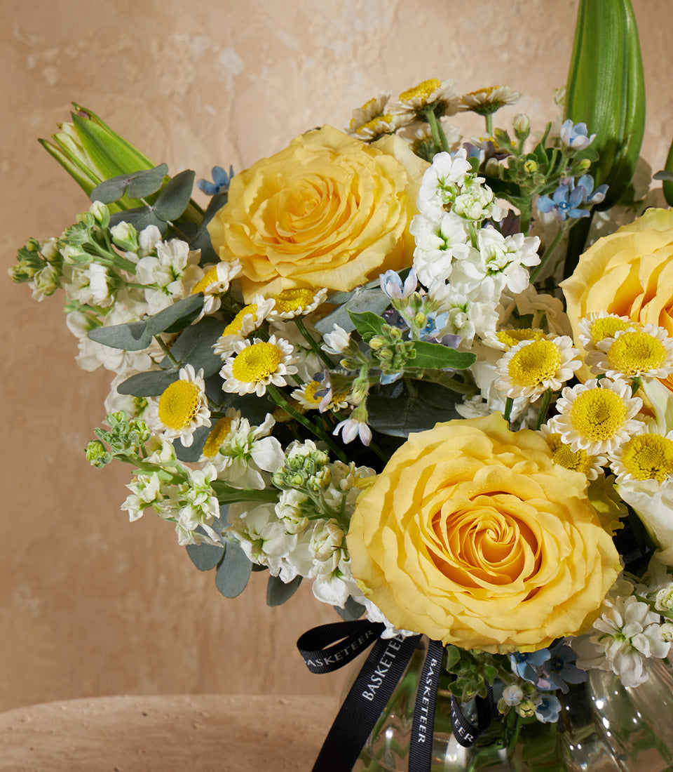 Golden Charm mini vase with yellow roses, white daisies, and eucalyptus in fresh flower arrangement