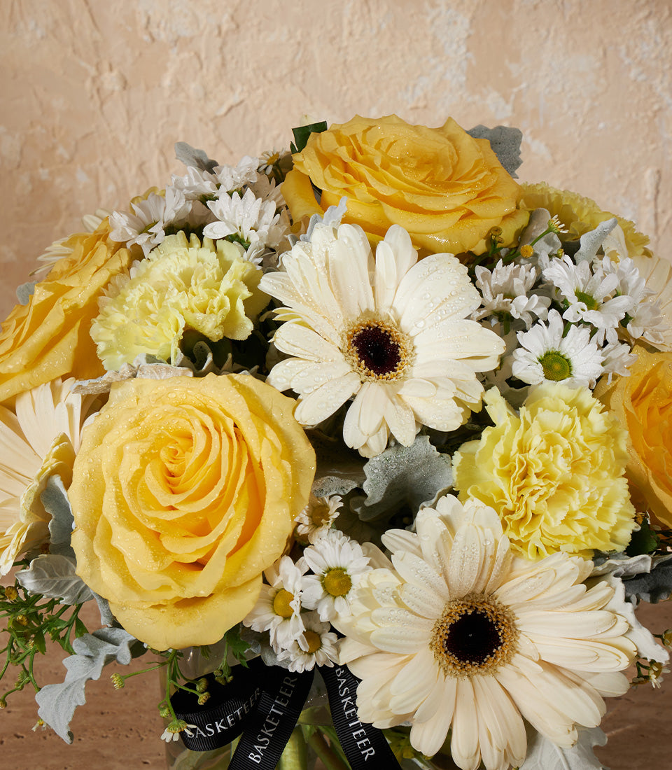Golden Charm fresh flower vase with yellow roses, white gerbera daisies, and carnations in premium arrangement