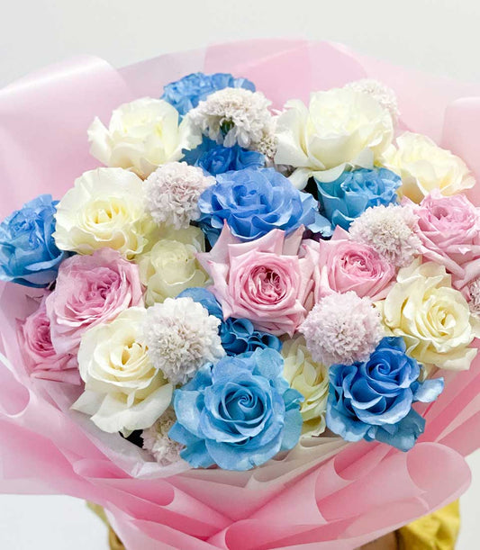 Pastel Dreams rose bouquet with light blue, pink, and cream roses in pink paper wrapping