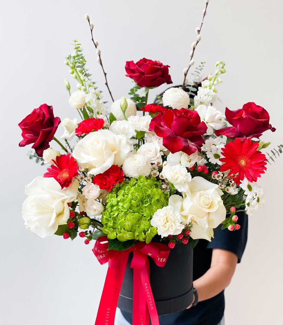 Red and white rose arrangement with hydrangeas in luxury black gift box, tied with satin ribbon