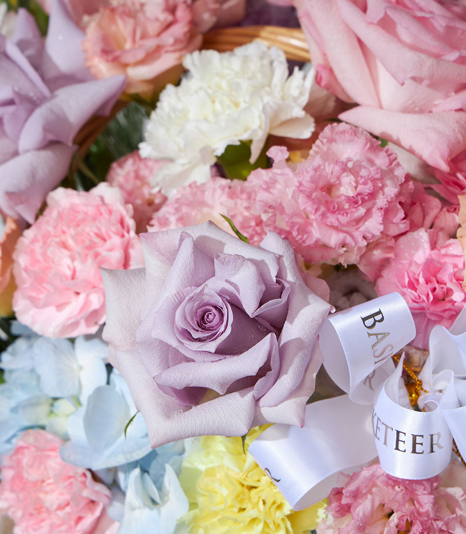 Lavender rose and pastel carnation flower basket with hydrangea and satin ribbon, perfect birthday gift arrangement