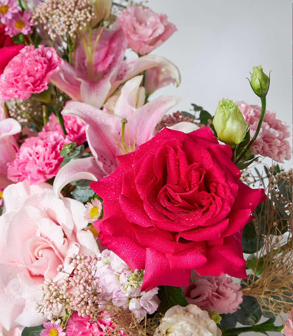 Pink and red roses, lilies, and carnations fresh flower bouquet for birthdays