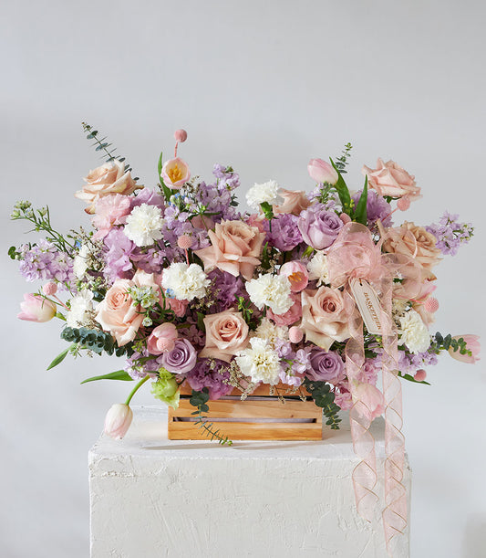 Pastel Romance flower arrangement in wooden crate with pink roses, white carnations, and tulips for get well wishes