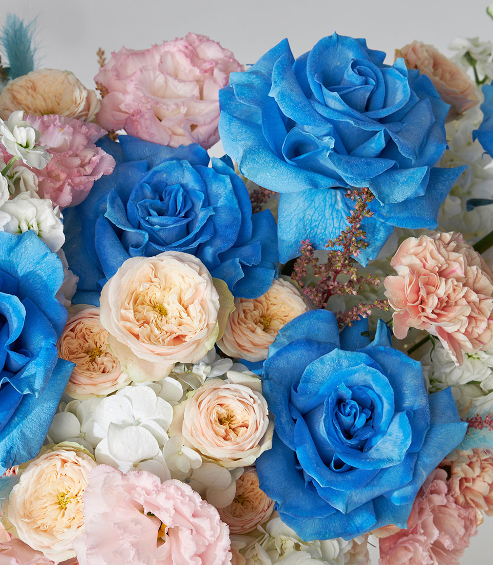 Blue and pastel roses with peach garden roses in luxury flower box arrangement