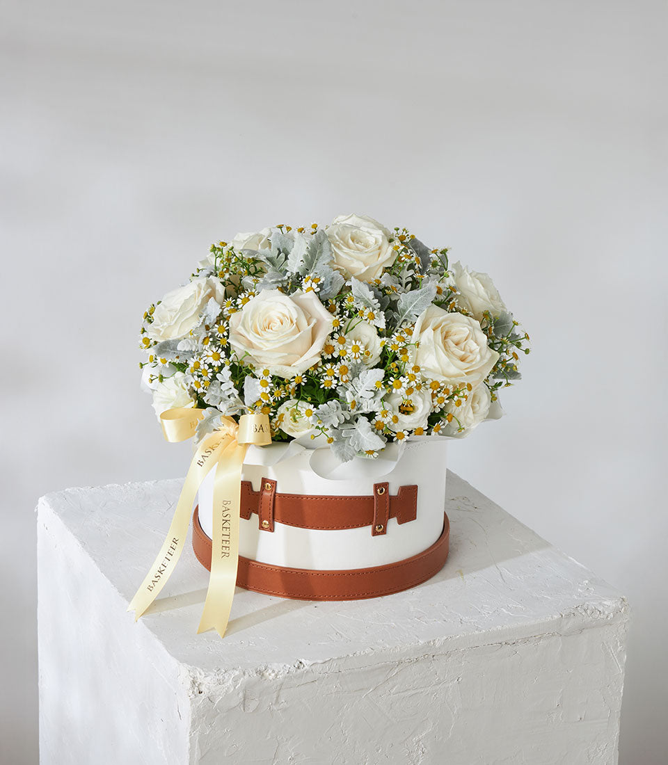 White roses and daisies in luxury leather flower box with gold studs and ribbon