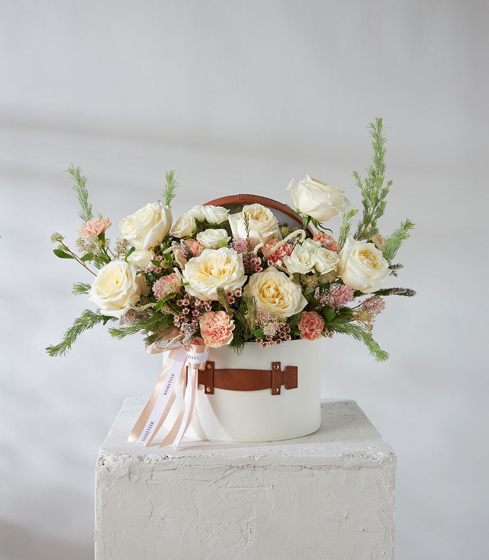 Luxury white and pink rose arrangement in leather-trimmed hatbox with carnations and greenery