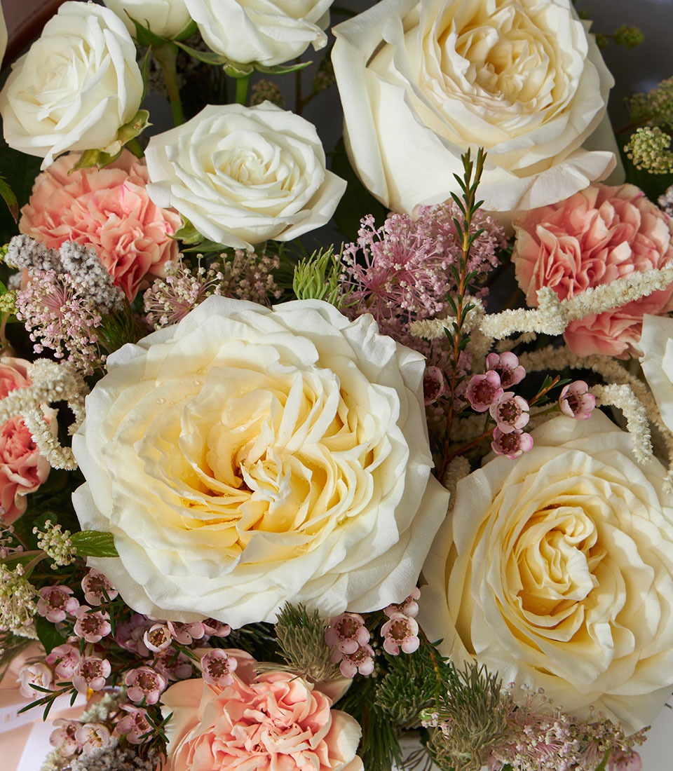 Candlelight roses and peach carnations in luxury leather flower box with fresh filler blooms