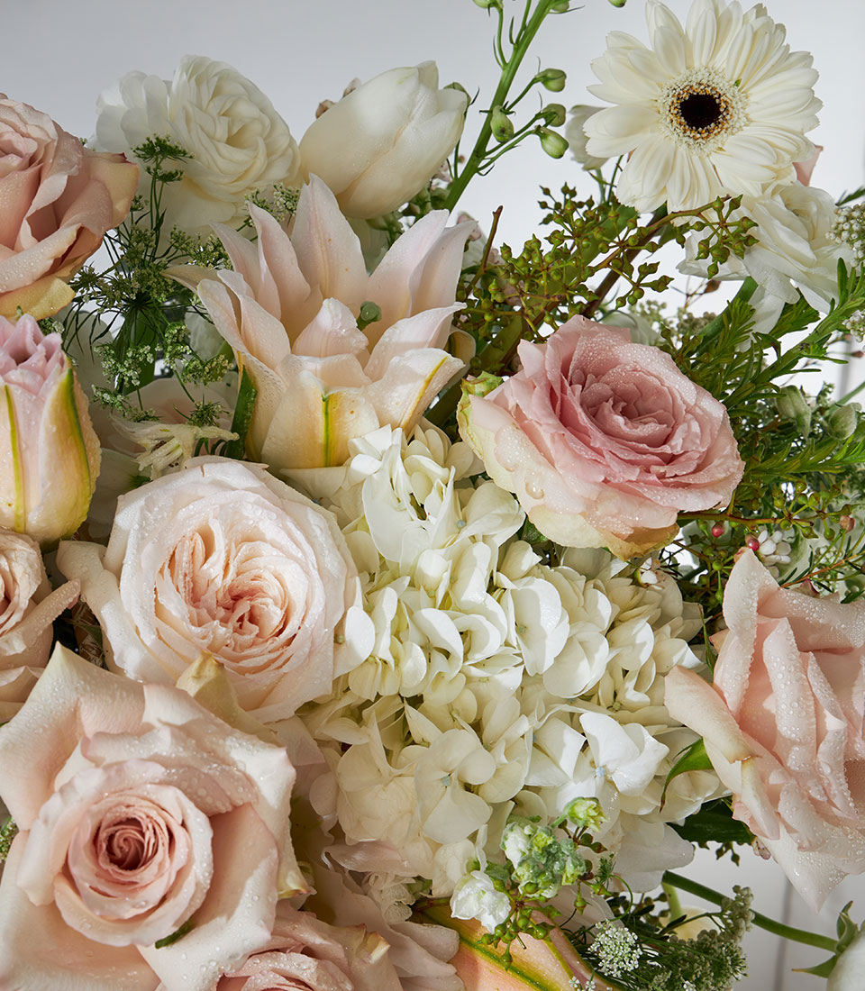 Quicksand roses with white lilies and ranunculus in luxury flower basket