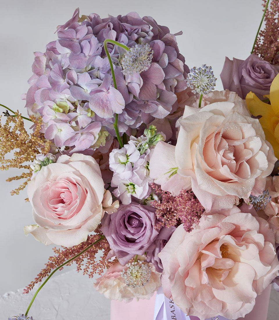 Premium velvet flower box with yellow, pink, and purple roses, hydrangeas, and eucalyptus