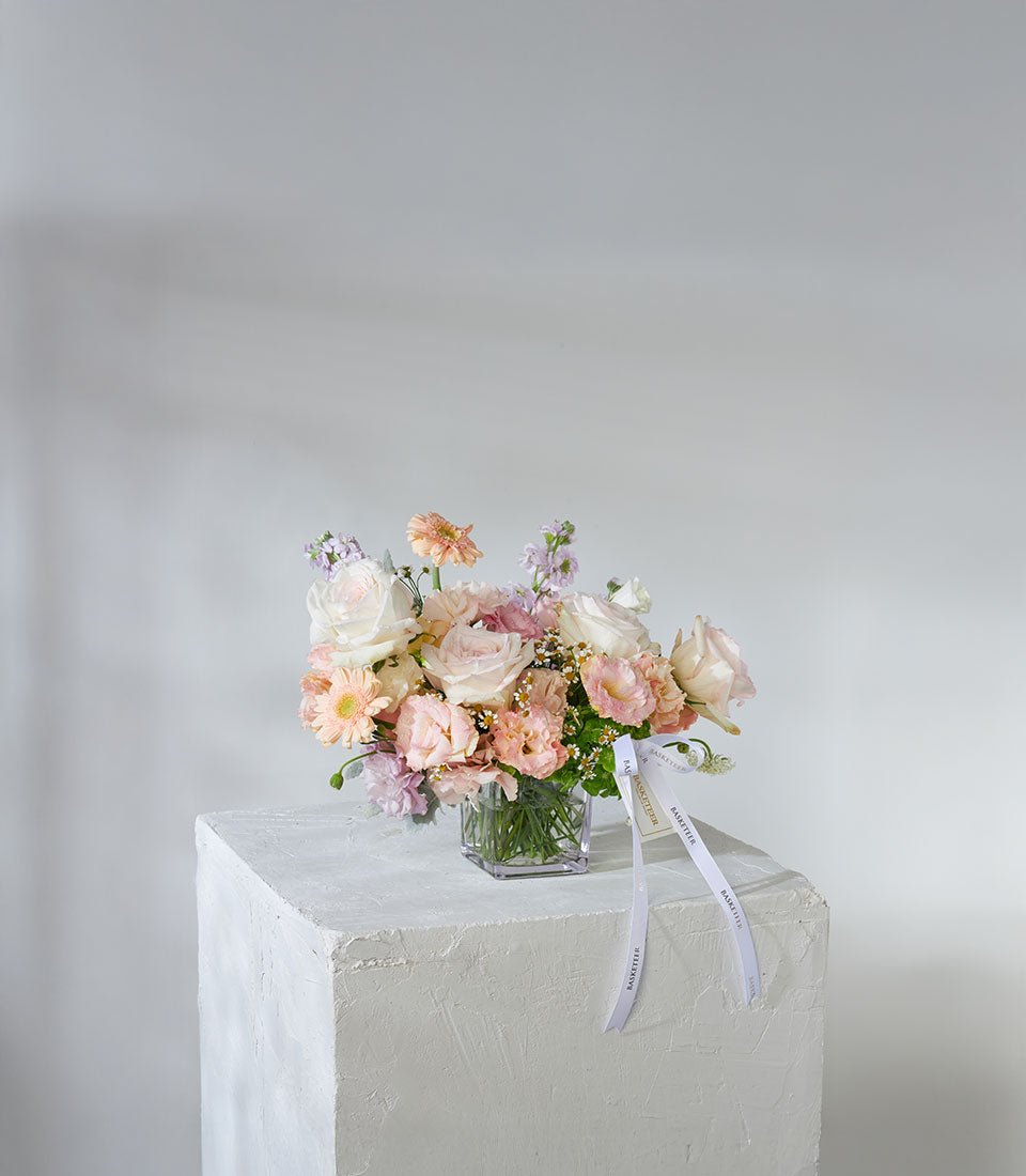 White and peach garden roses with gerbera daisies in square glass vase, premium fresh flower arrangement