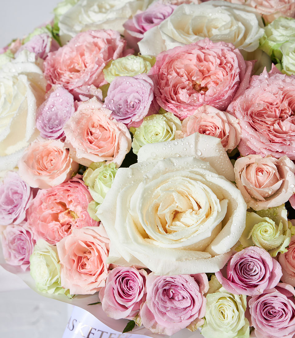Luxury pastel rose bouquet with cream, blush, lavender and peach blooms in premium gift box
