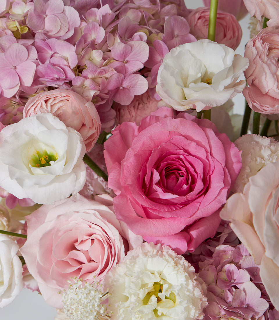 Nuage pink and white roses with ranunculus and tulips in pearl leather flower box