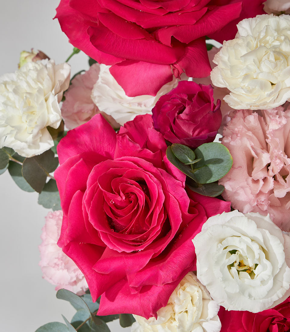 Lush pink roses and white lisianthus luxury flower box with eucalyptus greenery