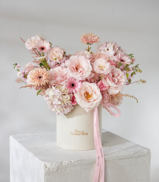 Pink and peach roses with hydrangeas in cream hatbox, premium fresh flower gift arrangement