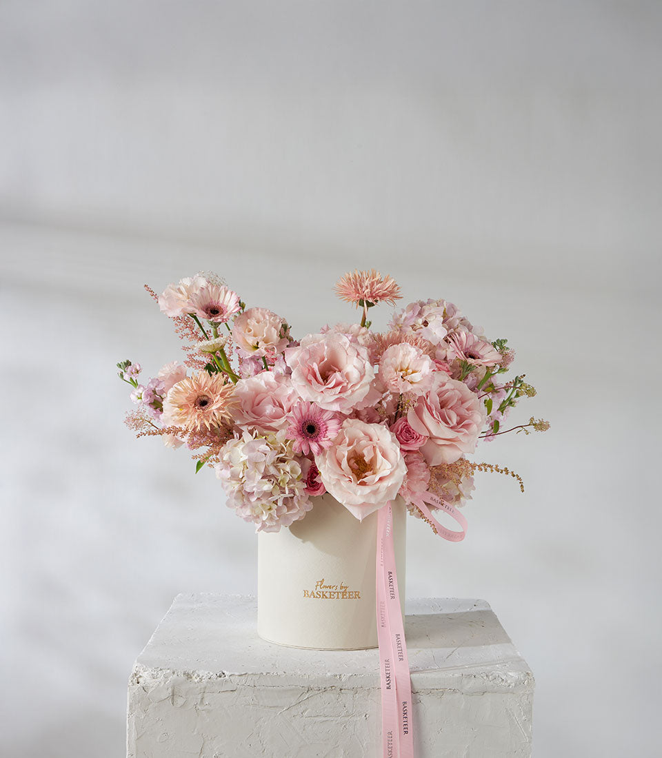 Pink and peach roses with hydrangea in cream hatbox luxury gift arrangement