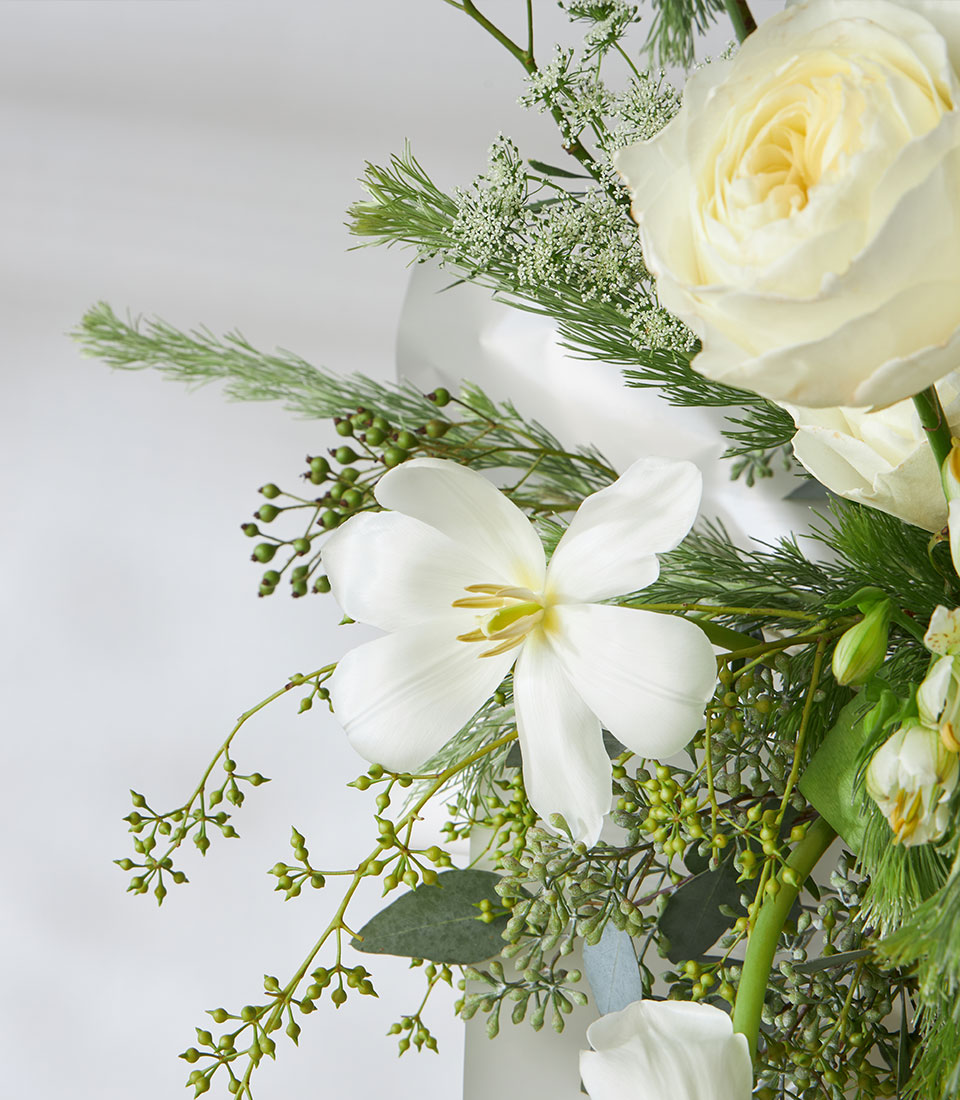 Elegant white roses and hydrangea fresh flower basket with eucalyptus and greenery