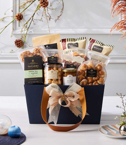 Exclusive Overseas Collection gift hamper with gourmet nuts, dried fruits, mango preserve, and jasmine tea in dark blue gift