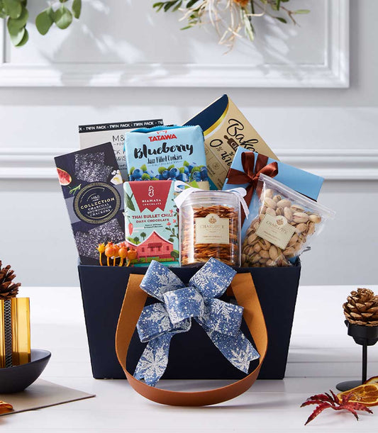 Dark blue premium gift basket with gourmet treats, blueberry cookies, dark chocolate, and crackers for New Year gifting