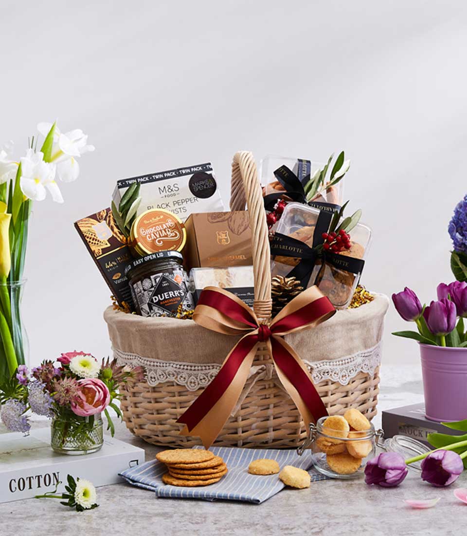 Luxury gift basket with gourmet treats, artisan baked goods, and fresh flowers for New Year celebrations