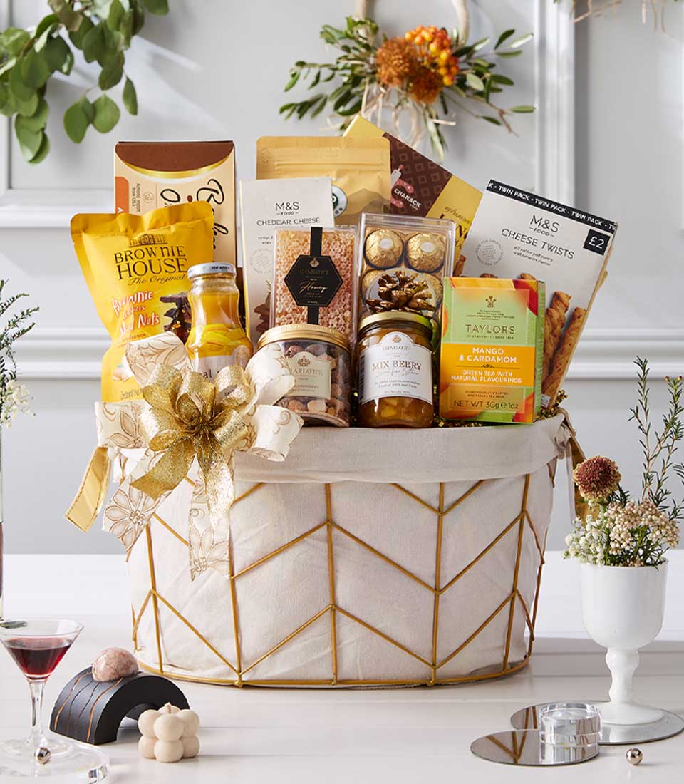 Basketeer luxury gift hamper with premium cheeses, gourmet cookies and mango tea. Elegant gold geometric basket with large gold ribbon. Perfect corporate gift Bangkok.