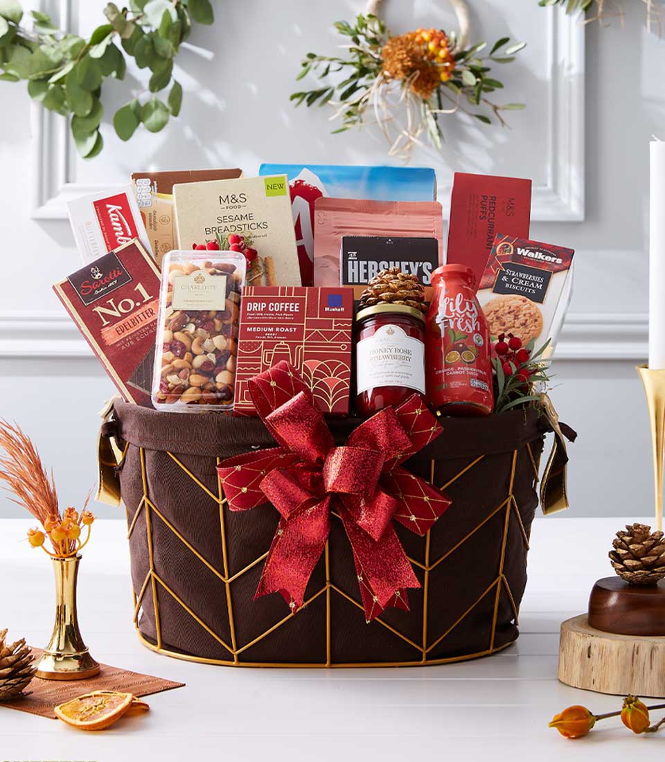 Luxury gourmet gift hamper with chocolate, coffee, jam and premium treats in gold-framed basket, New Year gift