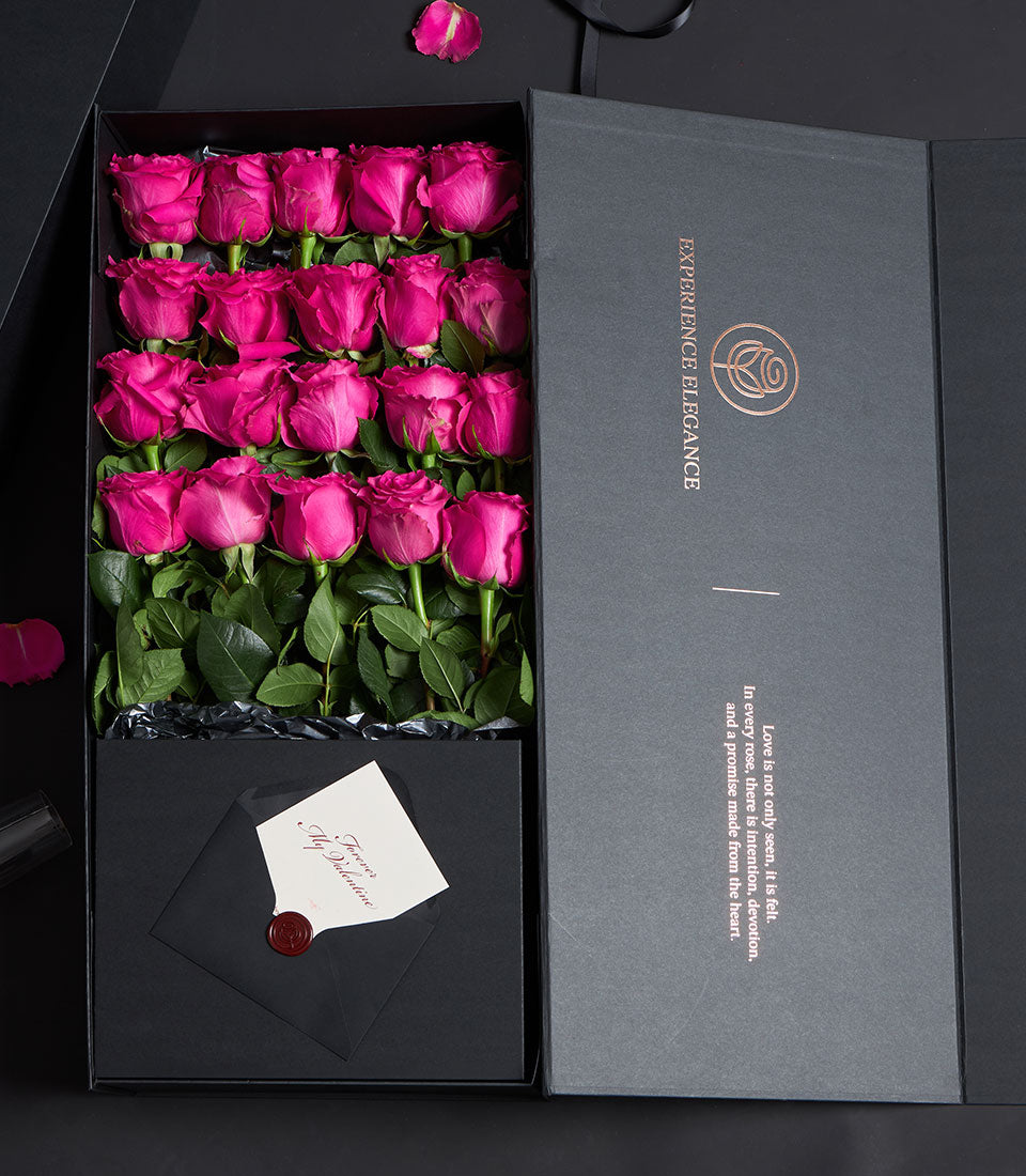 Luxury Valentine gift box with two dozen fuchsia pink Ecuadorian roses, dark grey packaging with copper embossed details