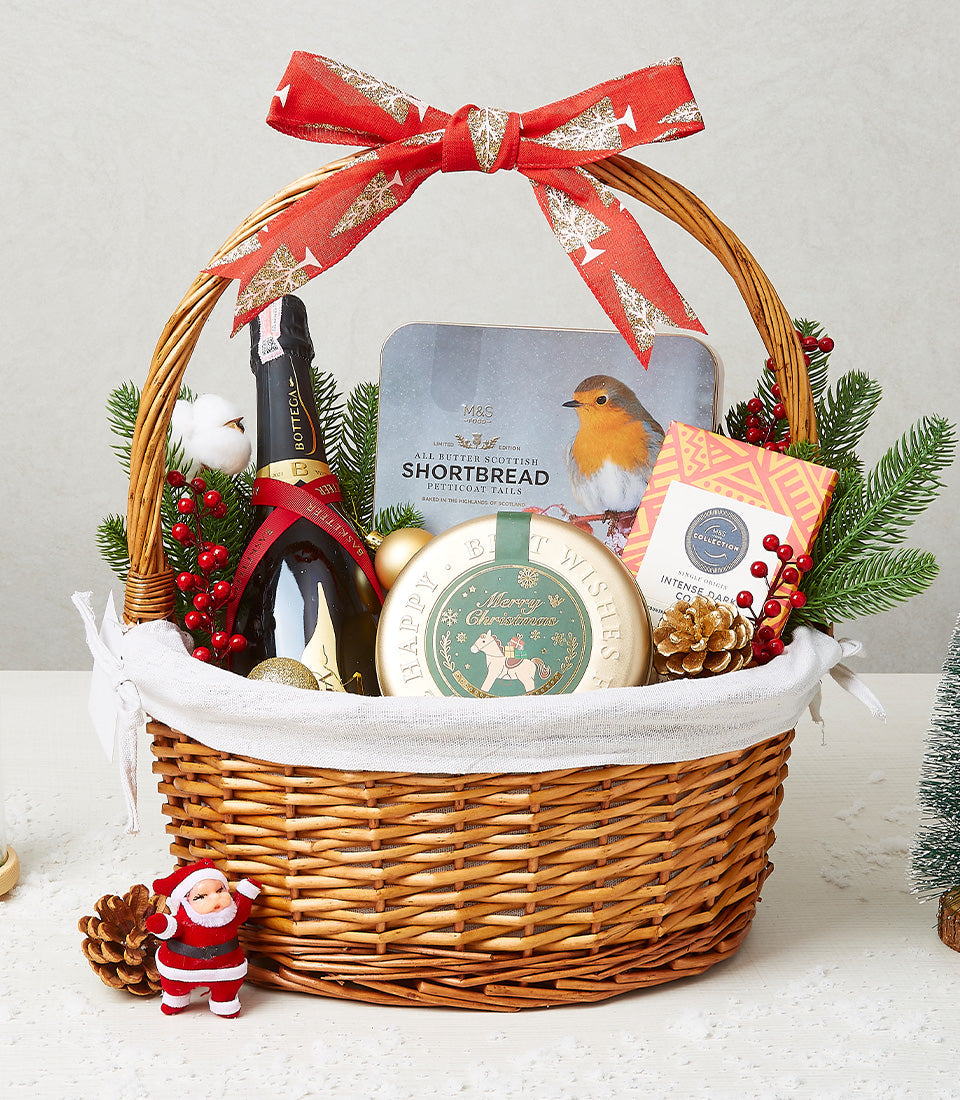 Wicker Christmas gift basket with Bottega sparkling wine, Scottish shortbread tin, dark chocolate, and festive gold baubles