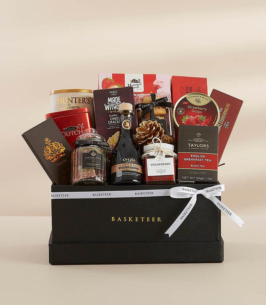 Luxury New Year gift hamper with gourmet snacks, balsamic vinegar, tea, and jam in black leather-finish box with white ribbon
