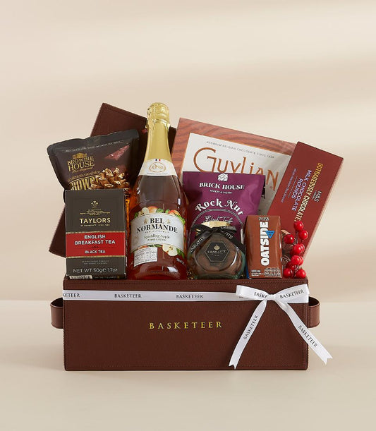 Luxury New Year gift hamper with sparkling cider, gourmet chocolates, tea, and artisan treats in brown leather box