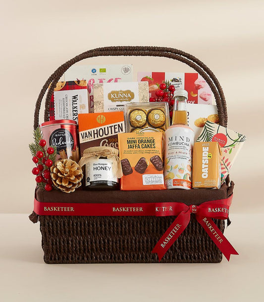 Holiday Magic wicker gift basket with gourmet treats, red ribbon bow, and festive berries for New Year celebrations